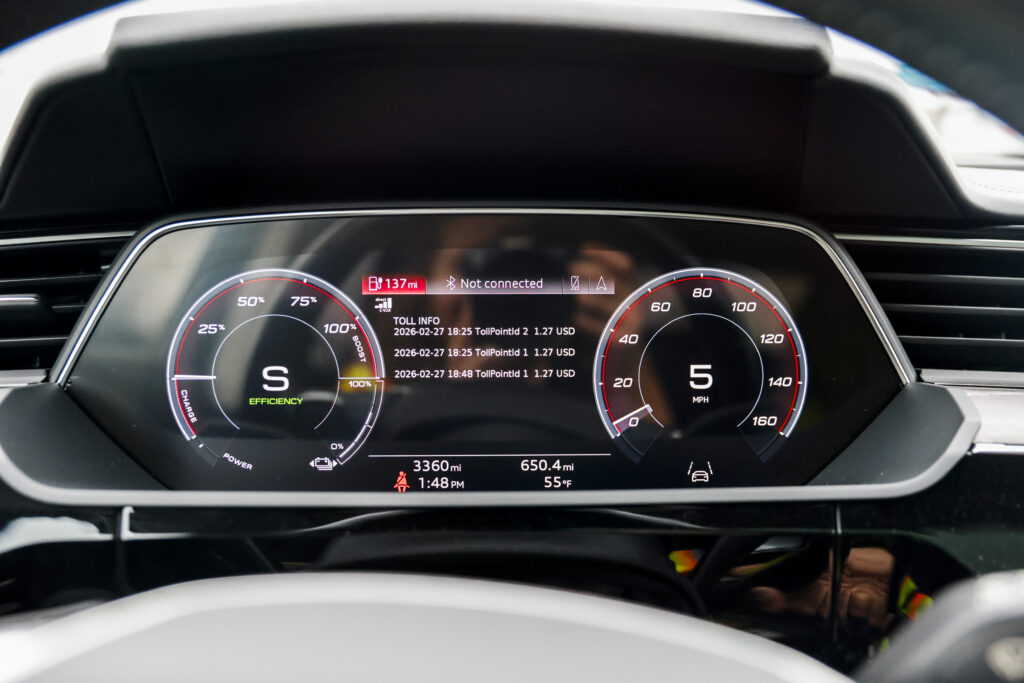 Close up on a vehicle dashboard that shows notifications about toll charges and safety updates for motorists in North Carolina.